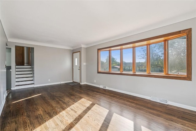 705 Grant Wood Dr SE, Cedar Rapids, IA 52403 - unfurnished living room featuring dark wood-style floors and stairs