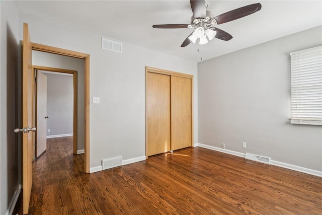 705 Grant Wood Dr SE, Cedar Rapids, IA 52403 - unfurnished bedroom featuring dark wood-type flooring, a closet, and a ceiling fan
