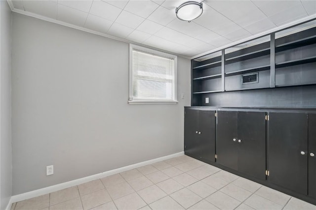 705 Grant Wood Dr SE, Cedar Rapids, IA 52403 - empty room with ornamental molding and light tile patterned floors
