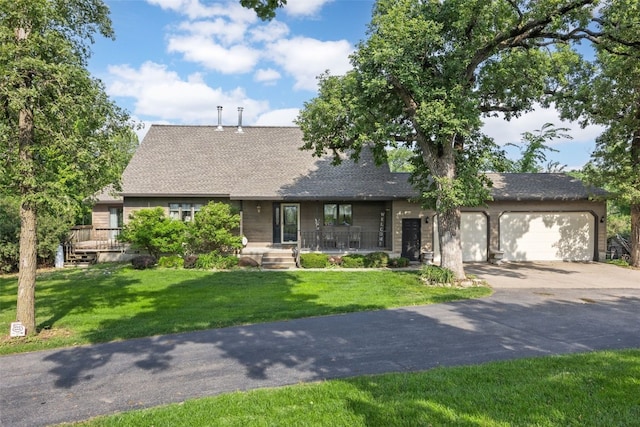 3496 E Otter Rd, Marion, IA 52302 - view of front of property featuring concrete driveway, a porch, a garage, and a front lawn