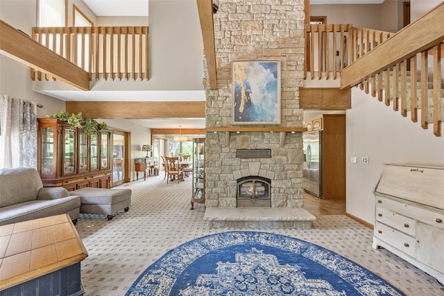 3496 E Otter Rd, Marion, IA 52302 - living area with a towering ceiling, carpet flooring, and a stone fireplace