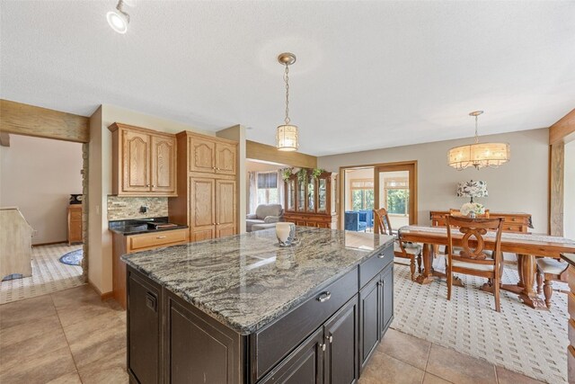 3496 E Otter Rd, Marion, IA 52302 - kitchen with stone countertops, a center island, pendant lighting, and tasteful backsplash
