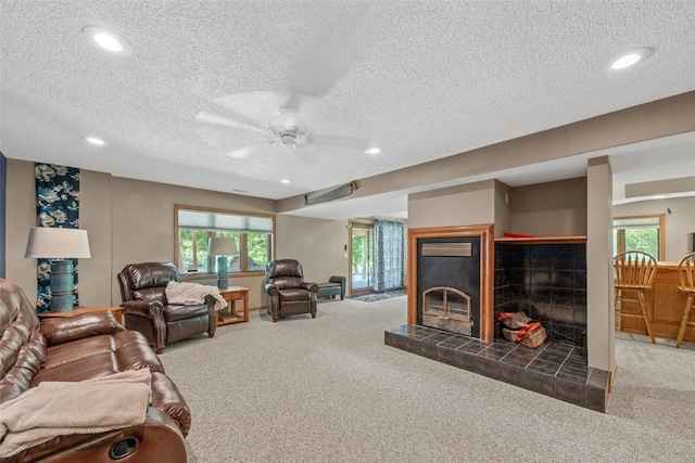 3496 E Otter Rd, Marion, IA 52302 - carpeted living room featuring ceiling fan, a fireplace, a textured ceiling, and recessed lighting