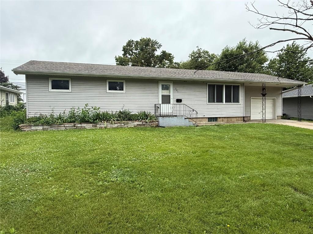 301 2nd Ave, Keystone, IA 52249 - view of front facade with a garage, a front lawn, and concrete driveway