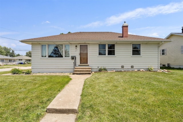425 28th St NW, Cedar Rapids, IA 52405 - view of front of house featuring a chimney, a front yard, entry steps, and roof with shingles