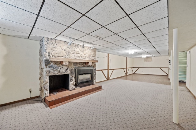425 28th St NW, Cedar Rapids, IA 52405 - finished below grade area featuring carpet floors, a stone fireplace, and a drop ceiling