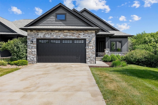 19 Pond Rdg, Coralville, IA 52241 - craftsman house with stone siding, a front yard, driveway, and a garage