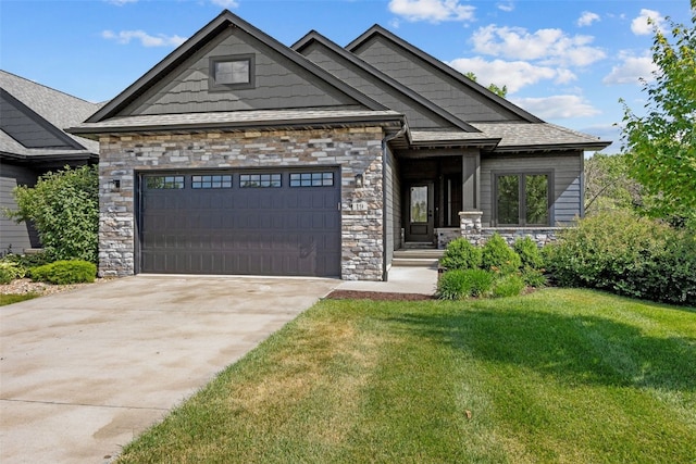 19 Pond Rdg, Coralville, IA 52241 - craftsman-style home with stone siding, a garage, a front lawn, and concrete driveway