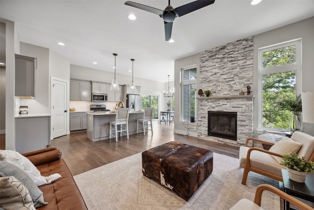 19 Pond Rdg, Coralville, IA 52241 - living area featuring healthy amount of natural light, wood finished floors, a ceiling fan, recessed lighting, and a chandelier