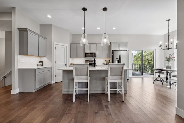19 Pond Rdg, Coralville, IA 52241 - kitchen with gray cabinets, stainless steel appliances, tasteful backsplash, dark wood-style flooring, and recessed lighting