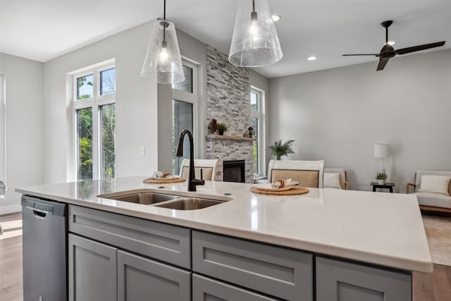 19 Pond Rdg, Coralville, IA 52241 - kitchen with stainless steel dishwasher, gray cabinets, open floor plan, wood finished floors, and recessed lighting