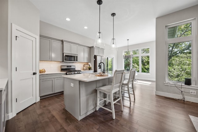 19 Pond Rdg, Coralville, IA 52241 - kitchen with stainless steel appliances, gray cabinets, light countertops, tasteful backsplash, and recessed lighting
