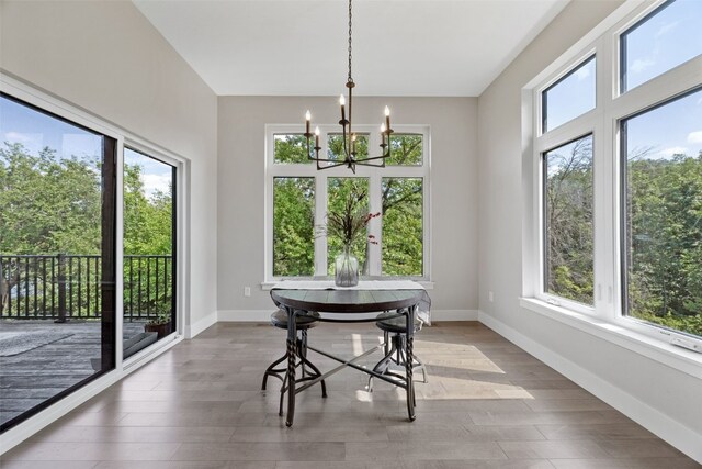 19 Pond Rdg, Coralville, IA 52241 - dining room featuring a chandelier, healthy amount of natural light, and light wood-style flooring