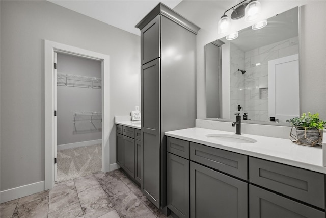 19 Pond Rdg, Coralville, IA 52241 - bathroom featuring vanity, tiled shower, and a walk in closet