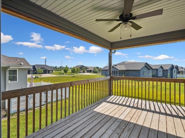 3602 Bluebird Dr SW, Cedar Rapids, IA 52404 - wooden terrace featuring a residential view, ceiling fan, and a yard
