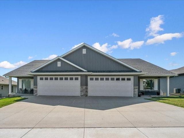 3602 Bluebird Dr SW, Cedar Rapids, IA 52404 - craftsman-style home with a garage, driveway, and stone siding