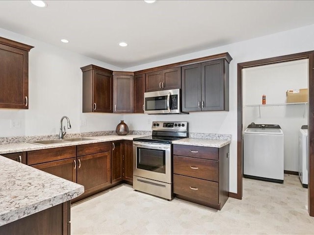 3602 Bluebird Dr SW, Cedar Rapids, IA 52404 - kitchen featuring appliances with stainless steel finishes, light countertops, dark brown cabinets, recessed lighting, and independent washer and dryer