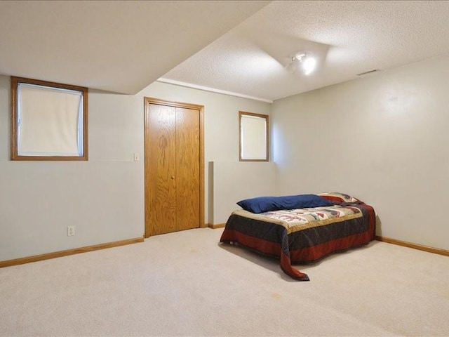 2066 Vista Cir NW, Cedar Rapids, IA 52405 - carpeted bedroom featuring baseboards and a textured ceiling