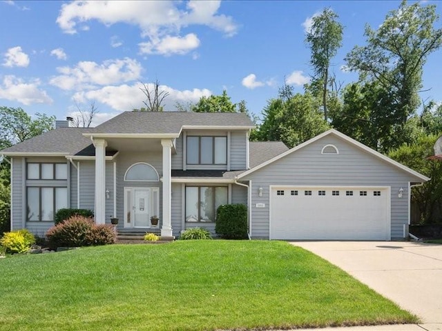2066 Vista Cir NW, Cedar Rapids, IA 52405 - view of front facade with a garage, concrete driveway, a front lawn, a chimney, and roof with shingles