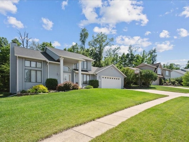 2066 Vista Cir NW, Cedar Rapids, IA 52405 - view of front facade featuring a front yard, driveway, an attached garage, and a chimney