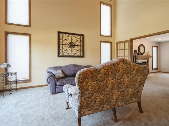 2066 Vista Cir NW, Cedar Rapids, IA 52405 - living room featuring light carpet, a high ceiling, and a fireplace