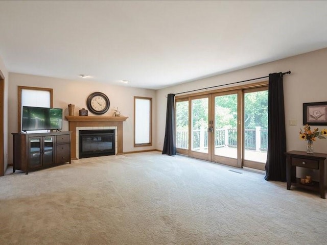 2066 Vista Cir NW, Cedar Rapids, IA 52405 - living area featuring french doors, a fireplace, and light colored carpet