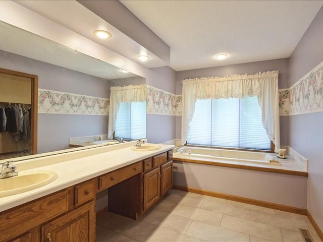 2066 Vista Cir NW, Cedar Rapids, IA 52405 - bathroom featuring a bath, double vanity, a spacious closet, and tile patterned floors