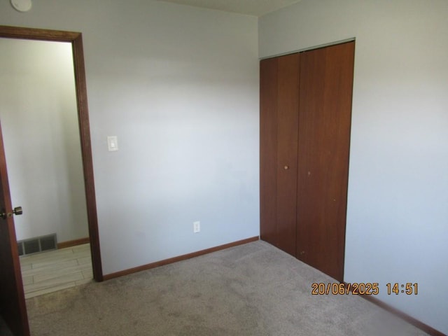 302 Meridian St, Tipton, IA 52772 - unfurnished bedroom featuring carpet and a closet