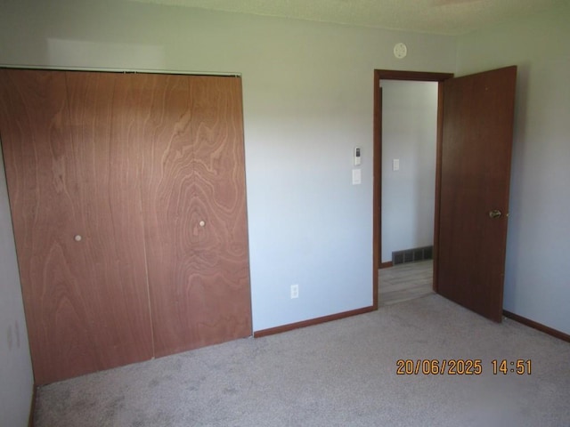 302 Meridian St, Tipton, IA 52772 - unfurnished bedroom featuring carpet floors and a closet