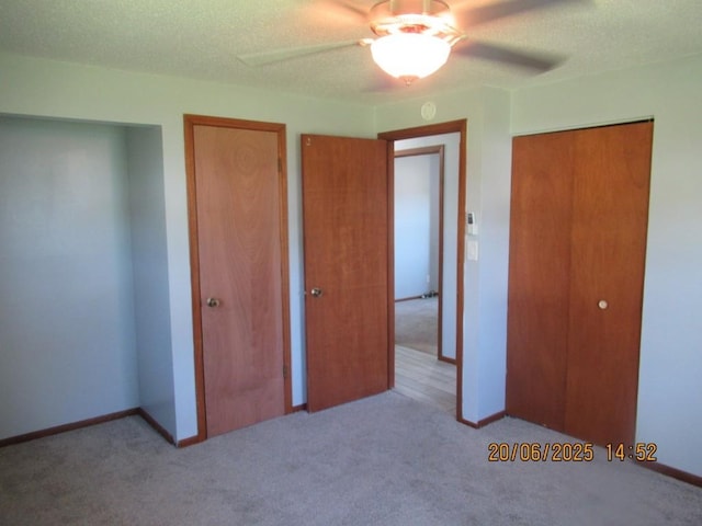 302 Meridian St, Tipton, IA 52772 - unfurnished bedroom featuring carpet floors, a closet, ceiling fan, and a textured ceiling