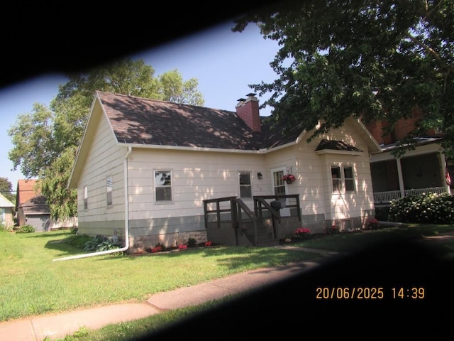 302 Meridian St, Tipton, IA 52772 - view of front facade with a front lawn, a chimney, and a shingled roof