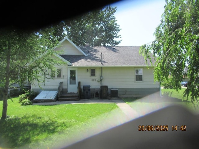 302 Meridian St, Tipton, IA 52772 - rear view of property with a shingled roof and a yard