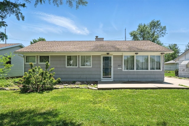 1635 Keith Dr NE, Cedar Rapids, IA 52402 - rear view of property featuring a lawn, a chimney, and roof with shingles