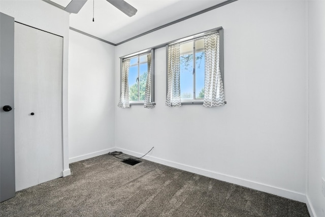 1635 Keith Dr NE, Cedar Rapids, IA 52402 - unfurnished bedroom with dark carpet, a closet, ornamental molding, and a ceiling fan