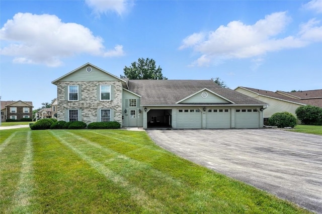 4121 Lexington Dr NE Unit B, Cedar Rapids, IA 52402 - view of front of house featuring a garage, asphalt driveway, a front yard, and stone siding