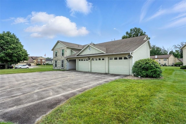 4121 Lexington Dr NE Unit B, Cedar Rapids, IA 52402 - traditional home with asphalt driveway, a garage, a front lawn, and roof with shingles