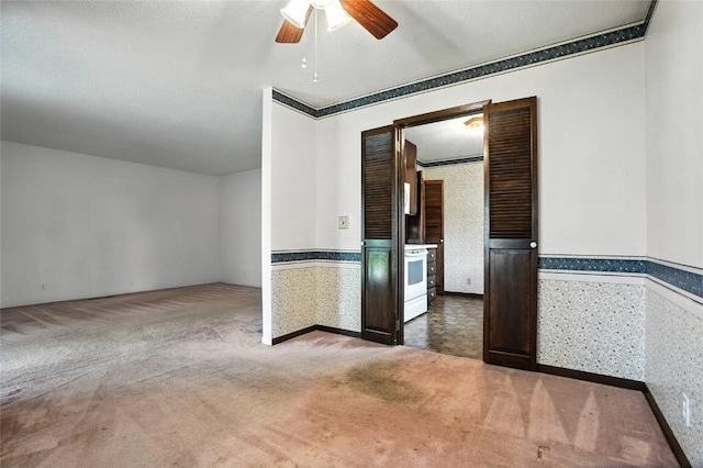 4121 Lexington Dr NE Unit B, Cedar Rapids, IA 52402 - spare room with a ceiling fan, carpet floors, and wainscoting