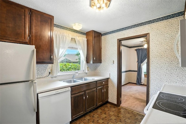 4121 Lexington Dr NE Unit B, Cedar Rapids, IA 52402 - kitchen featuring white appliances, wallpapered walls, light countertops, and a textured ceiling