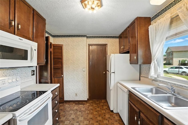 4121 Lexington Dr NE Unit B, Cedar Rapids, IA 52402 - kitchen featuring white appliances, wallpapered walls, light countertops, and a textured ceiling
