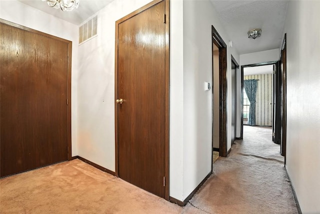 4121 Lexington Dr NE Unit B, Cedar Rapids, IA 52402 - hall featuring light carpet and a chandelier