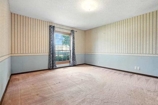 4121 Lexington Dr NE Unit B, Cedar Rapids, IA 52402 - carpeted spare room with wallpapered walls and a textured ceiling