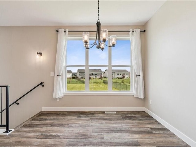 1326 Echo Ridge Ln, Marion, IA 52302 - unfurnished dining area featuring a chandelier and wood finished floors