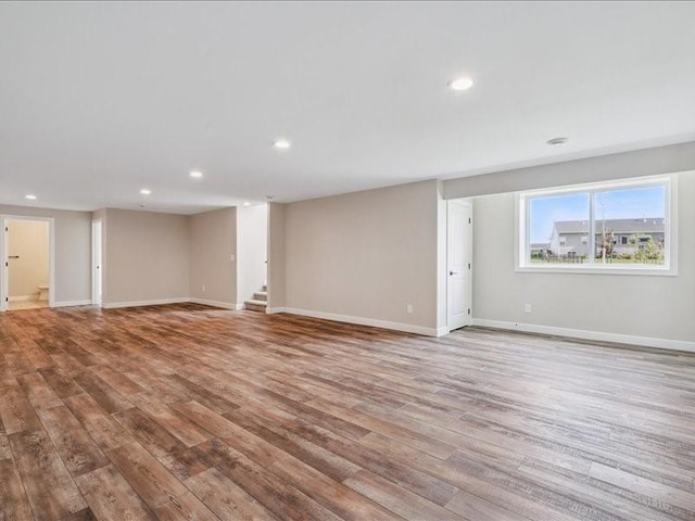 1326 Echo Ridge Ln, Marion, IA 52302 - unfurnished living room with wood finished floors, recessed lighting, and stairs