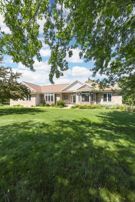 4452 Plumberry Rd, Ely, IA 52227 - ranch-style home with a front yard
