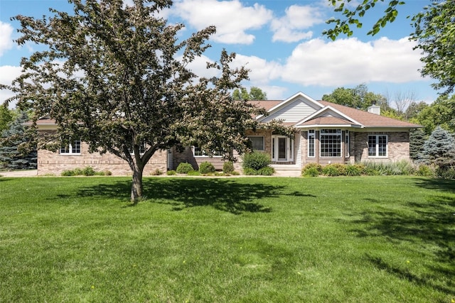 4452 Plumberry Rd, Ely, IA 52227 - view of front of house featuring a front yard, brick siding, and a chimney