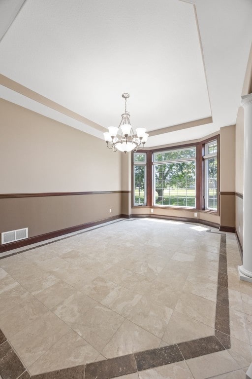 4452 Plumberry Rd, Ely, IA 52227 - empty room with a chandelier, a tray ceiling, and inlaid floor details