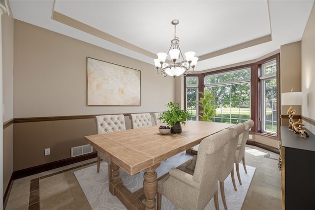 4452 Plumberry Rd, Ely, IA 52227 - dining room featuring a raised ceiling and a chandelier