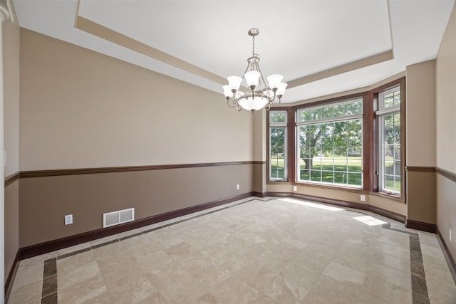 4452 Plumberry Rd, Ely, IA 52227 - spare room with a tray ceiling and a chandelier
