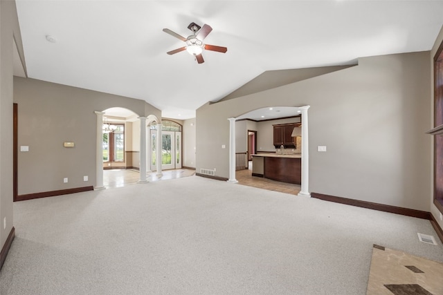 4452 Plumberry Rd, Ely, IA 52227 - unfurnished living room with decorative columns, ceiling fan, arched walkways, lofted ceiling, and light colored carpet
