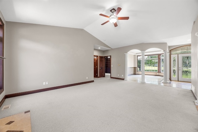 4452 Plumberry Rd, Ely, IA 52227 - unfurnished living room with decorative columns, light carpet, a ceiling fan, vaulted ceiling, and arched walkways